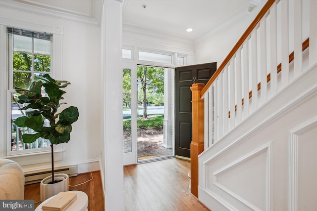 979 Powhatan St, Alexandria, VA 22314 - foyer entrance featuring baseboard heating, stairs, recessed lighting, wood finished floors, and ornamental molding