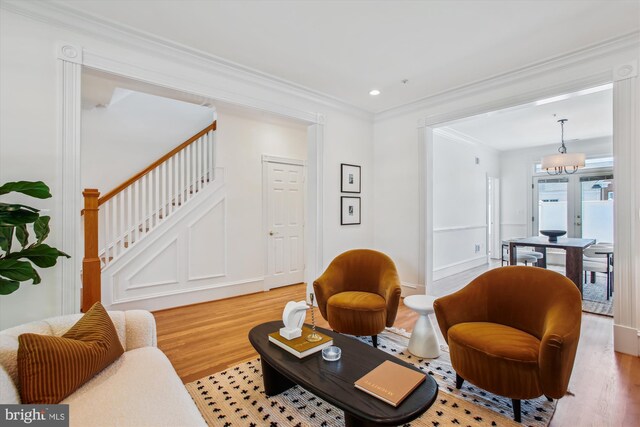 979 Powhatan St, Alexandria, VA 22314 - living area with recessed lighting, ornamental molding, light wood finished floors, and stairs