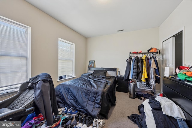 carpeted bedroom with visible vents