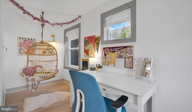 home office featuring wood finished floors and baseboards