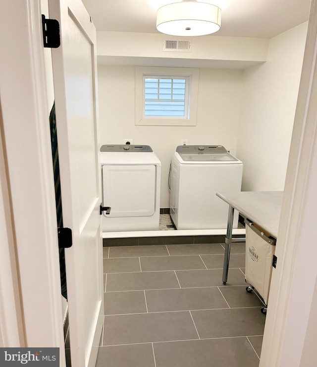 clothes washing area featuring separate washer and dryer and tile patterned flooring