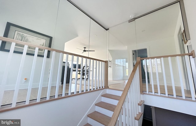 staircase featuring ceiling fan