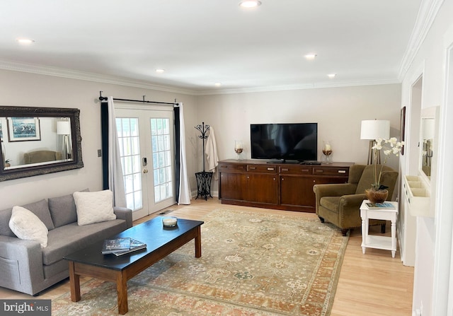 living area featuring light wood-type flooring, french doors, ornamental molding, and recessed lighting