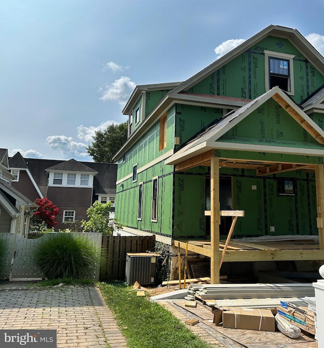view of side of home featuring central air condition unit, fence, and a wooden deck