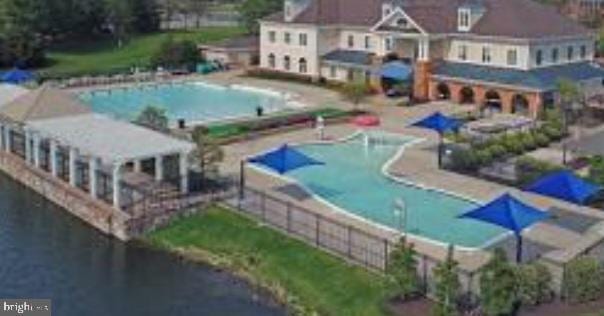 view of swimming pool with a water view