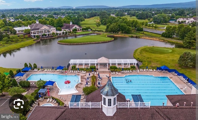 birds eye view of property with a water view and view of golf course