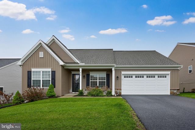 410 Orchid Cir, Lebanon, PA 17046 - view of front of property featuring board and batten siding, asphalt driveway, a garage, and a front lawn