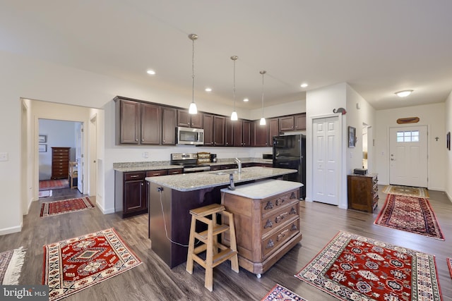 410 Orchid Cir, Lebanon, PA 17046 - kitchen featuring stainless steel appliances, dark brown cabinetry, dark wood-style floors, an island with sink, and recessed lighting