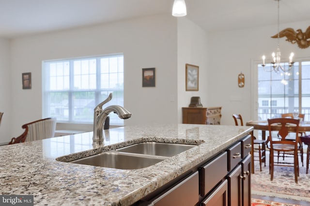 410 Orchid Cir, Lebanon, PA 17046 - kitchen featuring a sink, a chandelier, light stone countertops, and pendant lighting