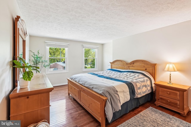 15690 Buck Ln, Dumfries, VA 22025 - bedroom featuring baseboards, a textured ceiling, and dark wood-style floors