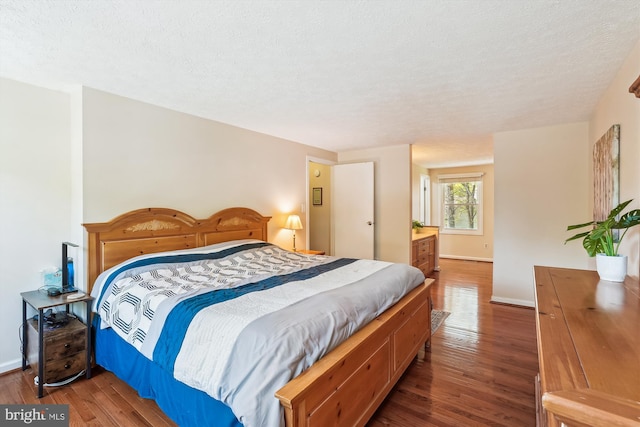 15690 Buck Ln, Dumfries, VA 22025 - bedroom with wood finished floors, a textured ceiling, and baseboards