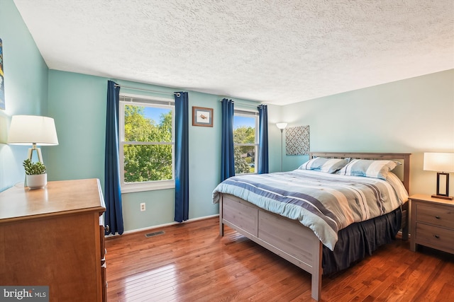 15690 Buck Ln, Dumfries, VA 22025 - bedroom with a textured ceiling, baseboards, and wood-type flooring