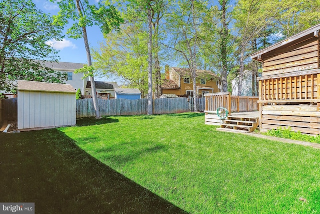 15690 Buck Ln, Dumfries, VA 22025 - view of yard with a wooden deck, a fenced backyard, a storage unit, and an outdoor structure