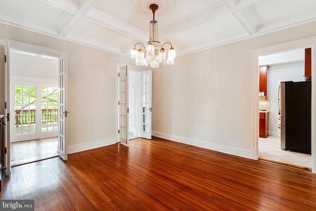 interior space with baseboards, a notable chandelier, light wood-type flooring, and coffered ceiling