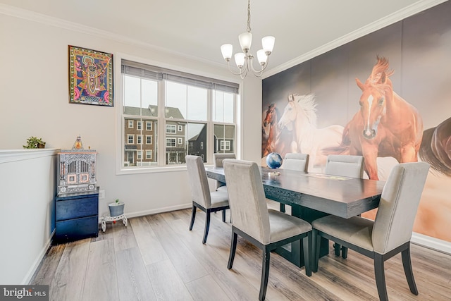 dining room featuring a notable chandelier, baseboards, ornamental molding, and wood finished floors