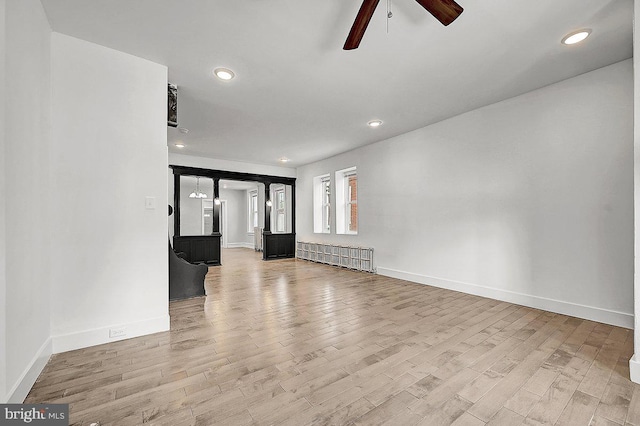 unfurnished living room featuring ceiling fan, recessed lighting, light wood finished floors, and baseboards