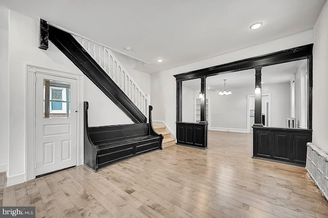 entryway featuring radiator heating unit, stairs, light wood-style flooring, and recessed lighting