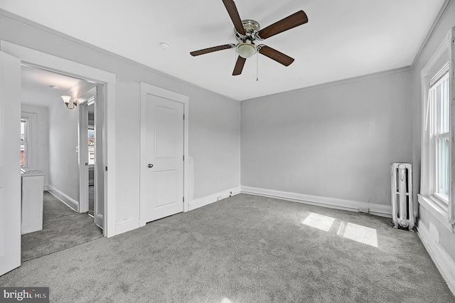 unfurnished bedroom featuring radiator, carpet floors, and multiple windows