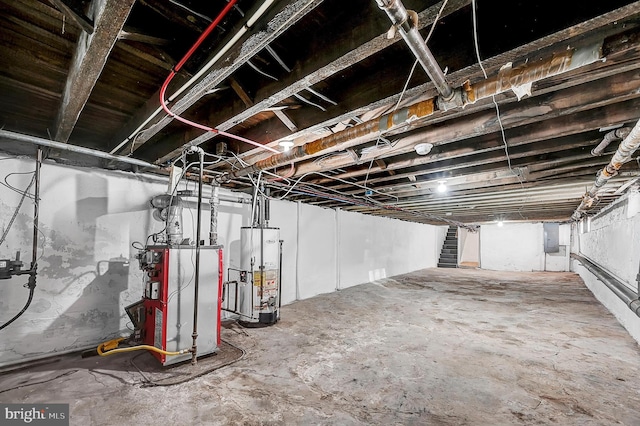 unfinished below grade area with stairs, electric panel, and water heater