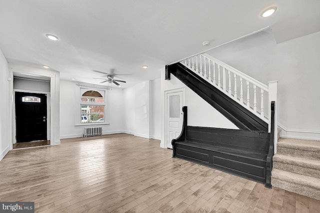 unfurnished living room with recessed lighting, stairs, and wood finished floors