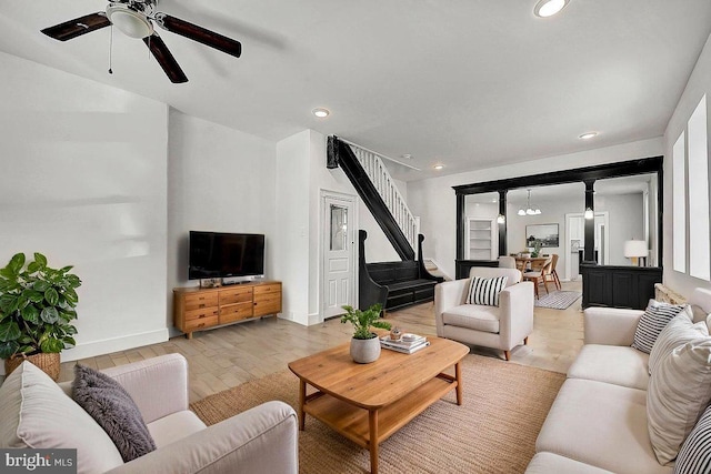 living area featuring recessed lighting, a ceiling fan, and baseboards