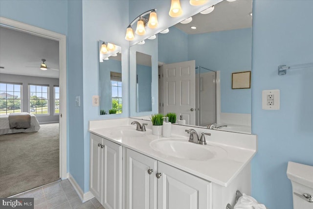 20973 Killawog Ter, Ashburn, VA 20147 - ensuite bathroom with a shower stall, double vanity, a ceiling fan, and baseboards