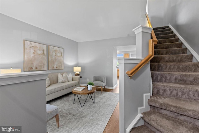 20973 Killawog Ter, Ashburn, VA 20147 - living area with stairway, wood finished floors, and baseboards