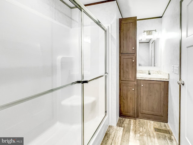 309 Fern Rd, Millville, NJ 08332 - full bathroom featuring an enclosed shower, wood finished floors, and vanity