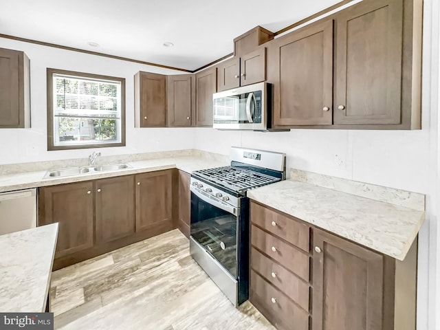 309 Fern Rd, Millville, NJ 08332 - kitchen with stainless steel appliances, a sink, light countertops, and light wood finished floors