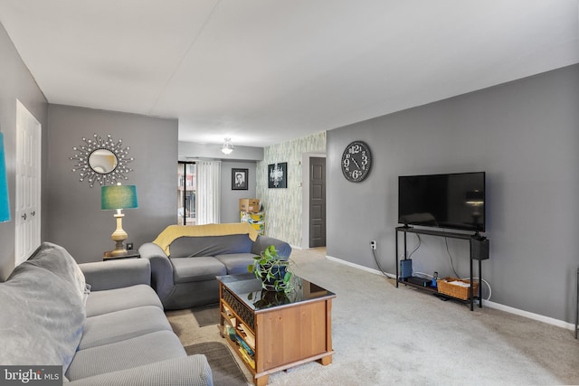 living room featuring light carpet and baseboards