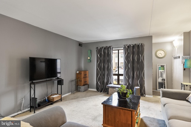 carpeted living room with baseboards