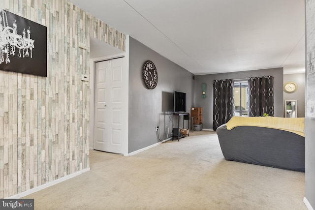 living room featuring baseboards, carpet flooring, and an accent wall
