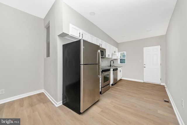 2828 Woodbrook Ave, Baltimore, MD 21217 - kitchen with visible vents, baseboards, light wood-style flooring, appliances with stainless steel finishes, and white cabinetry