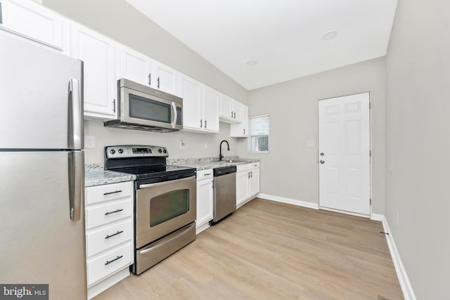 2828 Woodbrook Ave, Baltimore, MD 21217 - kitchen with stainless steel appliances, a sink, light wood-style floors, white cabinetry, and light stone countertops
