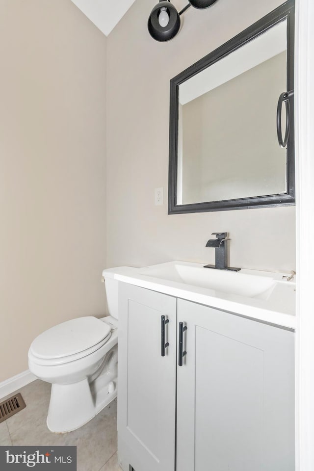 2828 Woodbrook Ave, Baltimore, MD 21217 - half bathroom with tile patterned flooring, visible vents, toilet, and vanity
