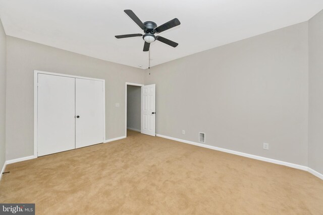 2828 Woodbrook Ave, Baltimore, MD 21217 - unfurnished bedroom featuring a closet, baseboards, visible vents, and light colored carpet