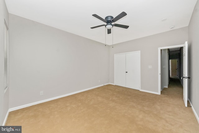 2828 Woodbrook Ave, Baltimore, MD 21217 - unfurnished bedroom with ceiling fan, a closet, baseboards, and light carpet