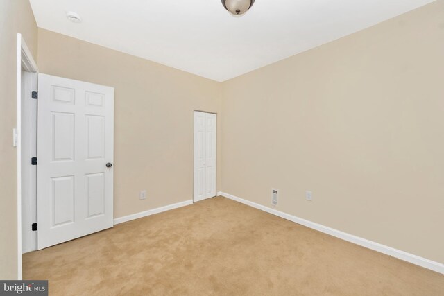 2828 Woodbrook Ave, Baltimore, MD 21217 - unfurnished bedroom with light carpet, a closet, visible vents, and baseboards