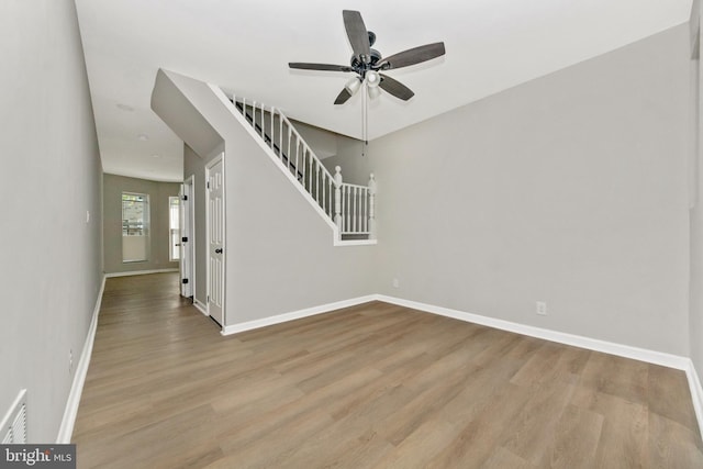2828 Woodbrook Ave, Baltimore, MD 21217 - spare room featuring ceiling fan, baseboards, wood finished floors, and stairs