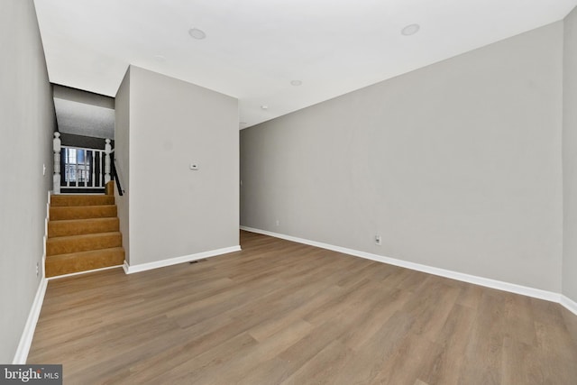 2828 Woodbrook Ave, Baltimore, MD 21217 - unfurnished living room featuring baseboards, wood finished floors, and stairway