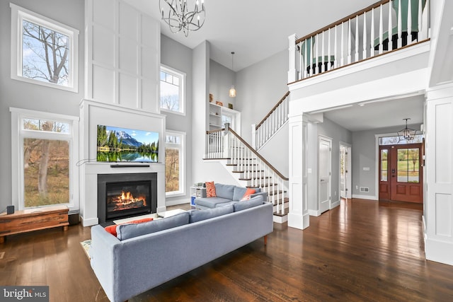 59 N Ridgemont Way, Shepherdstown, WV 25443 - living room featuring a chandelier, a towering ceiling, a fireplace with flush hearth, wood-type flooring, and stairway