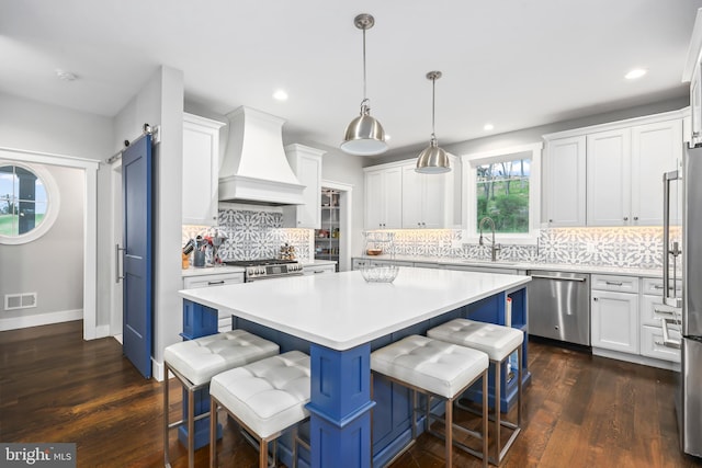 59 N Ridgemont Way, Shepherdstown, WV 25443 - kitchen with stainless steel appliances, custom exhaust hood, a sink, a center island, and white cabinets