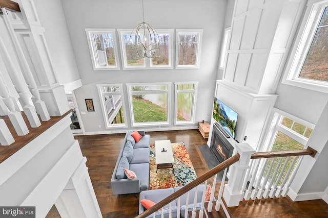 59 N Ridgemont Way, Shepherdstown, WV 25443 - living room featuring a towering ceiling, baseboards, healthy amount of natural light, and a chandelier