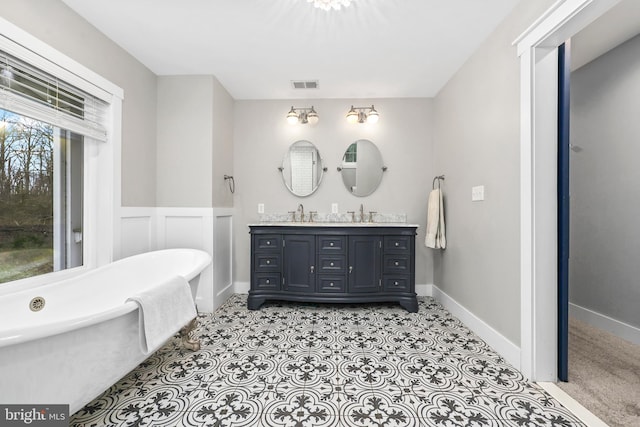 59 N Ridgemont Way, Shepherdstown, WV 25443 - bathroom with double vanity, a freestanding bath, and wainscoting