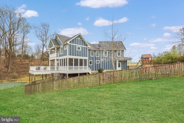59 N Ridgemont Way, Shepherdstown, WV 25443 - back of house with a playground, a sunroom, board and batten siding, a wooden deck, and roof with shingles
