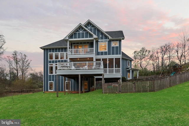59 N Ridgemont Way, Shepherdstown, WV 25443 - back of property at dusk featuring board and batten siding, a deck, a playground, and a balcony