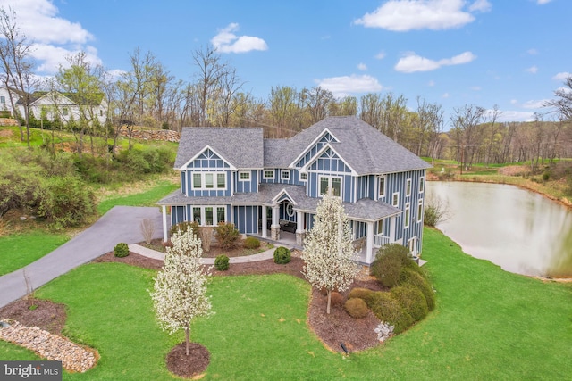 59 N Ridgemont Way, Shepherdstown, WV 25443 - rear view of house with driveway, a porch, a yard, a water view, and a shingled roof