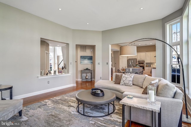 living area with baseboards, visible vents, recessed lighting, and wood finished floors