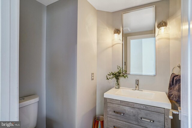 half bathroom with toilet and vanity