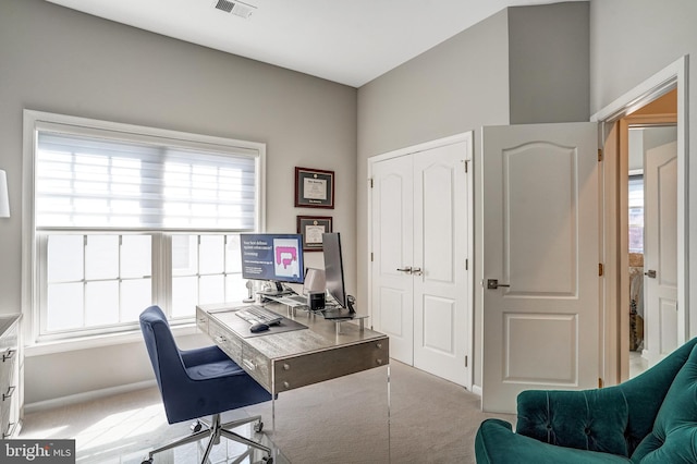 carpeted office with baseboards, a healthy amount of sunlight, and visible vents